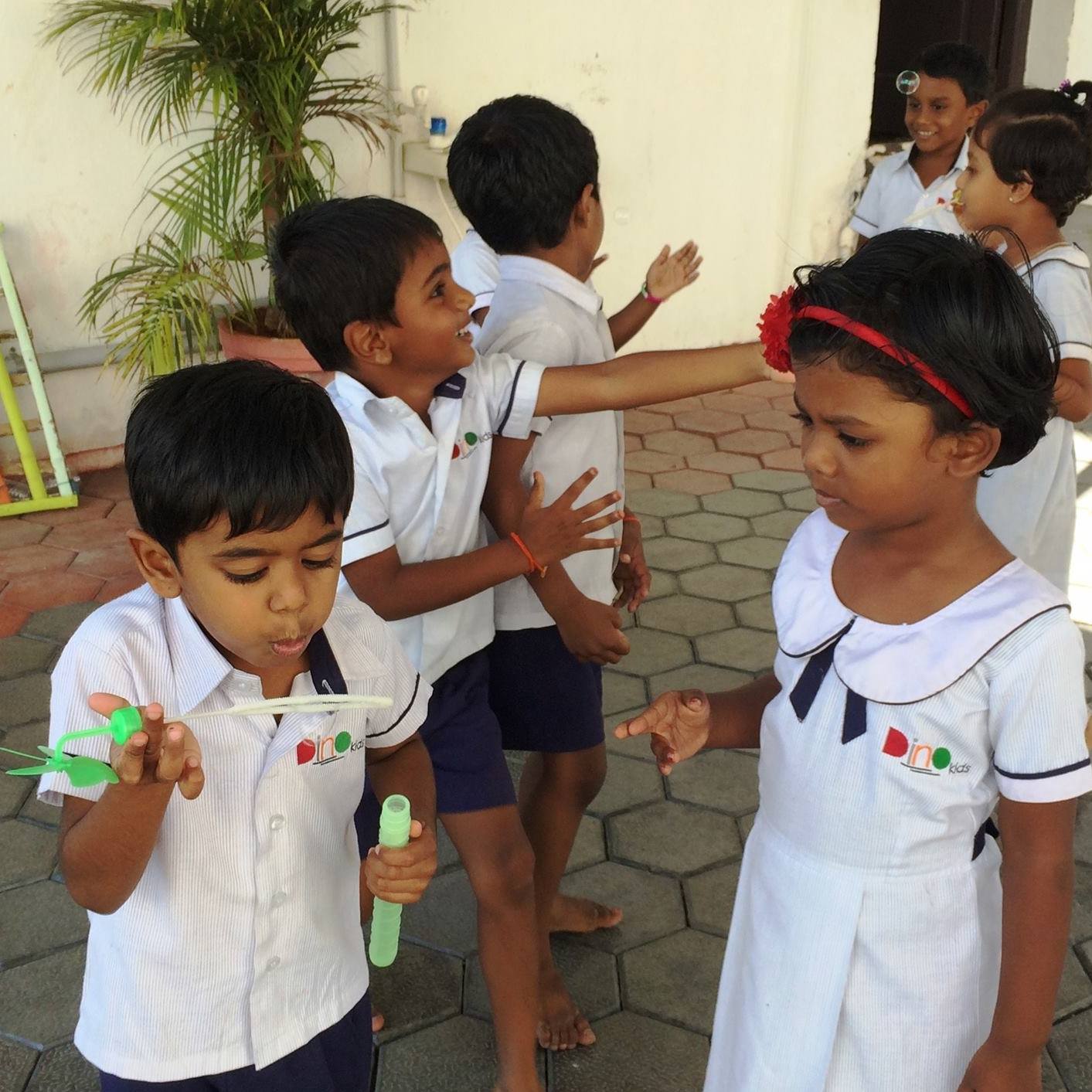 The kids all come together and enjoy sharing and playing with bubbles